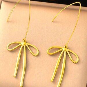 18K GOLD DIPPED ELONGATED BOW EARRINGS ON A LONG BODY